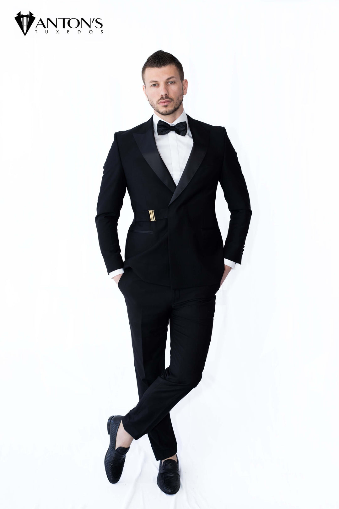 Groom wearing a peak lapel modern tuxedo made of 100% Italian wool, ideal for black tie weddings, available at Anton's Tuxedos.