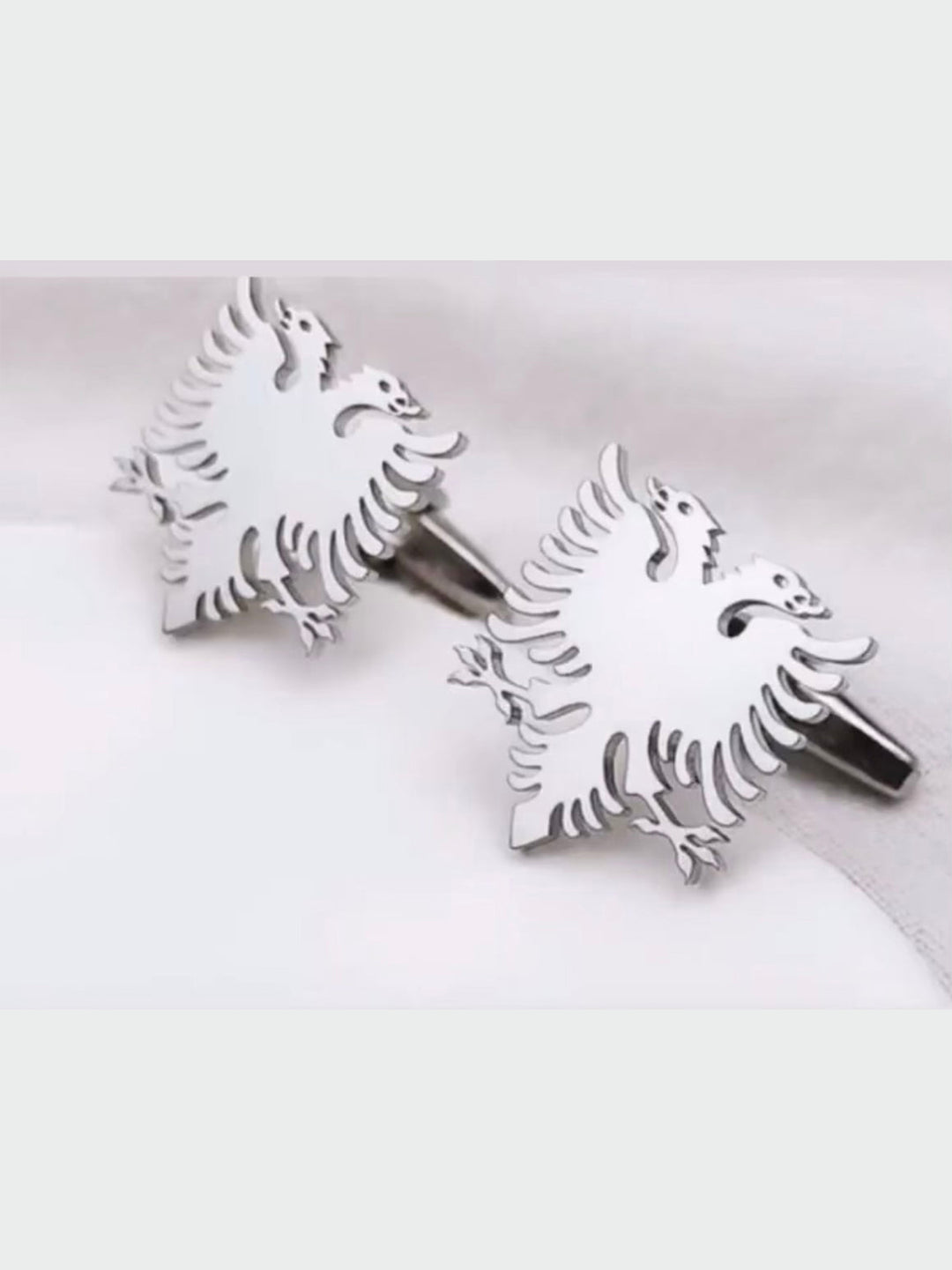 Shiny silver Albanian cufflinks featuring a double-headed eagle design, perfect for adding a touch of elegance to formal attire.