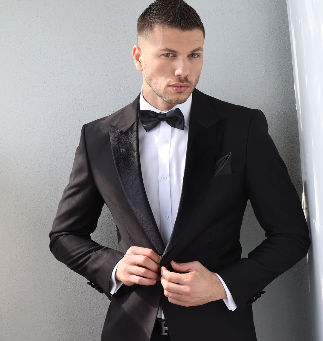 Man wearing Velvet Black Tuxedo with a bow-tie, elegantly styled for a formal event.