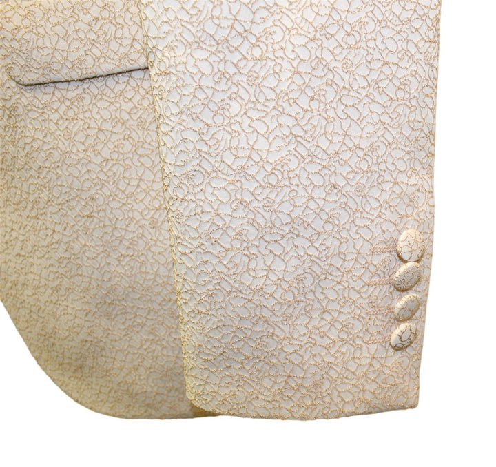 Close-up of sleeve detailing on an elegant Champagne Tuxedo jacket with intricate pattern and button accents.