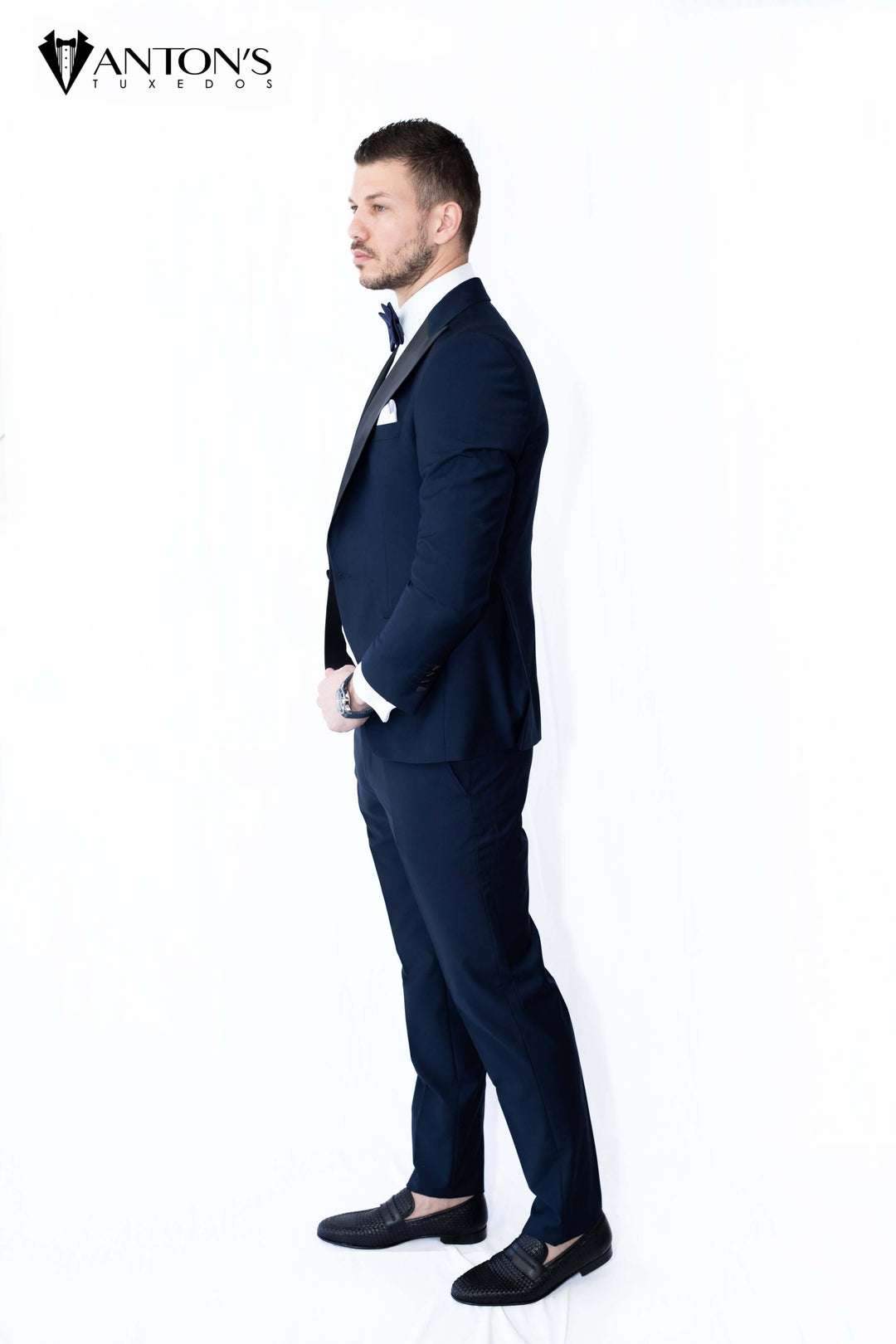 Groom in navy blue tuxedo with black peak lapel, perfect for formal menswear, wedding tuxedos, and classic high-quality groom attire